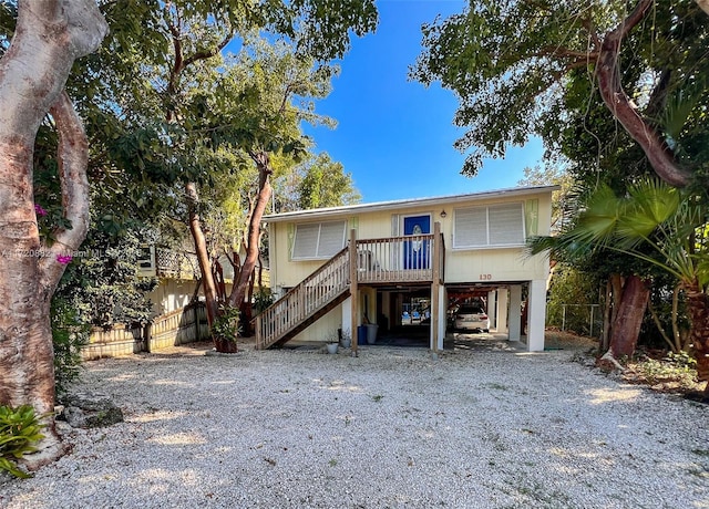 raised beach house featuring a carport