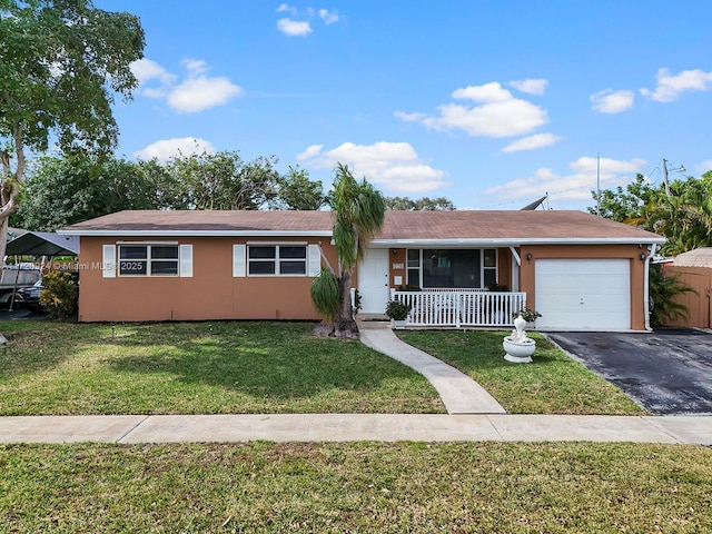 single story home with a porch, a garage, and a front lawn