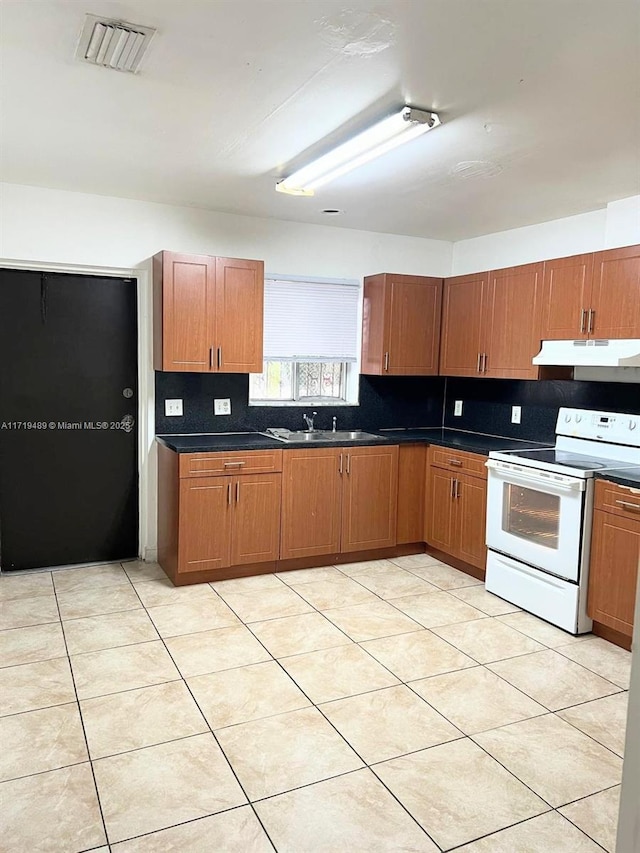 kitchen with light tile patterned flooring, white electric stove, sink, and tasteful backsplash