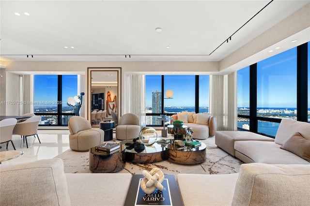 living room featuring plenty of natural light and a water view