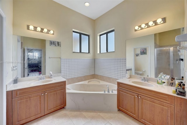 full bathroom featuring tile patterned flooring, vanity, independent shower and bath, and toilet