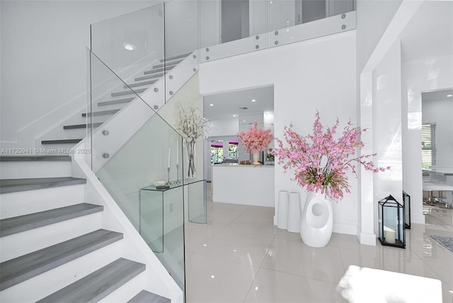 stairway featuring tile patterned floors and a wealth of natural light