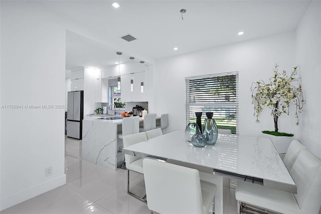 tiled dining room with sink