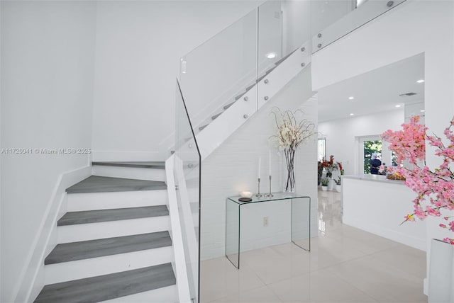 stairs featuring tile patterned floors