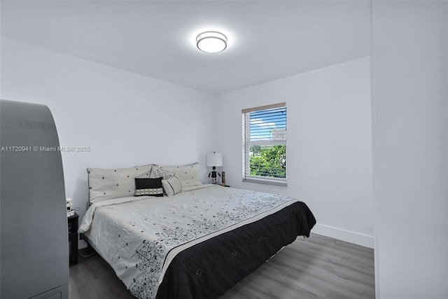 bedroom with dark wood-type flooring