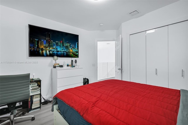 bedroom featuring a closet and light hardwood / wood-style floors