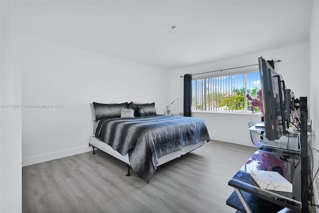 bedroom with hardwood / wood-style floors