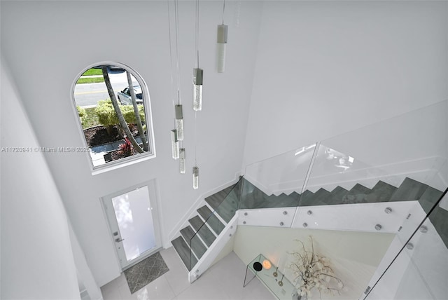 tiled foyer with a high ceiling