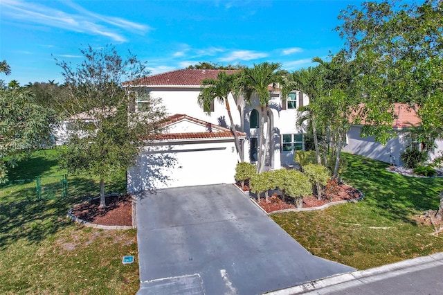 mediterranean / spanish-style house with a garage and a front yard