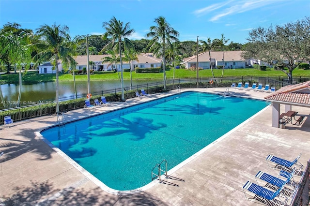 view of pool with a patio and a water view