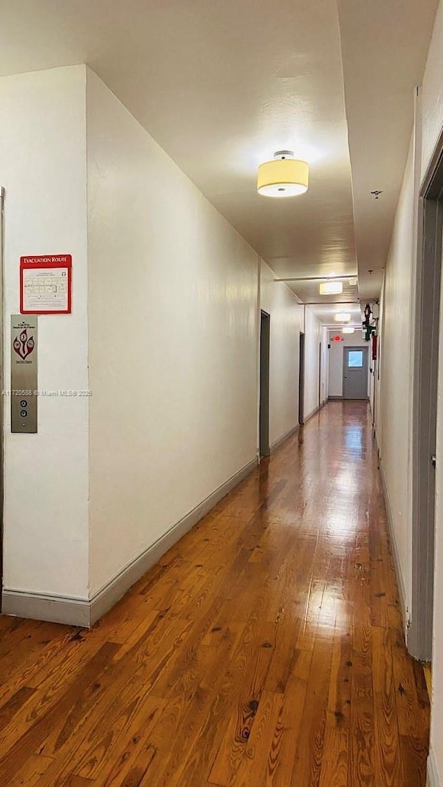 corridor featuring wood-type flooring