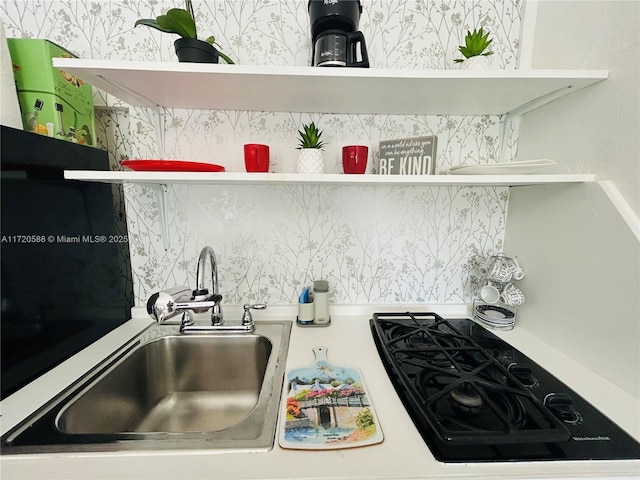 kitchen featuring gas stovetop, sink, and tasteful backsplash