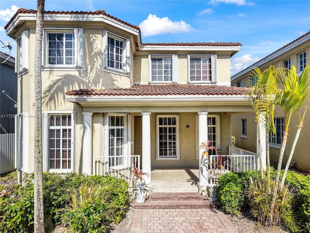 mediterranean / spanish-style house with a porch