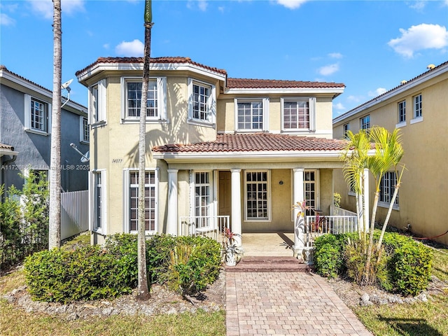 mediterranean / spanish-style house with covered porch