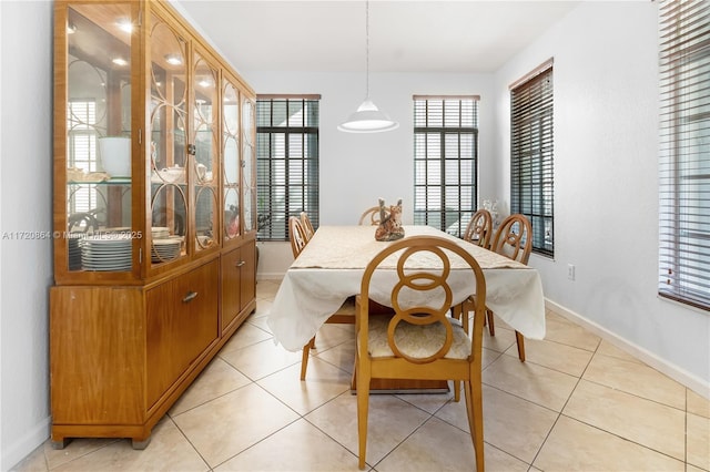 dining space featuring light tile patterned floors