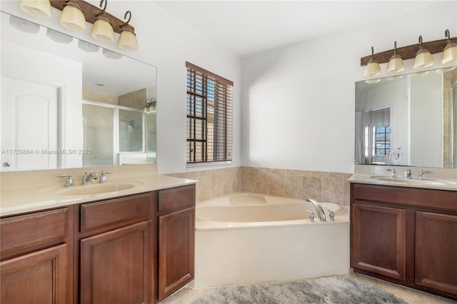 bathroom with tile patterned flooring, vanity, and shower with separate bathtub