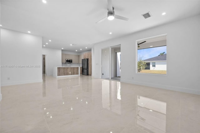 unfurnished living room with ceiling fan