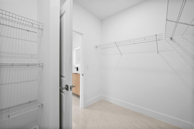 walk in closet featuring light tile patterned floors