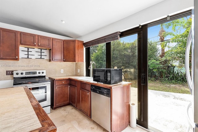 100 NE 51st St, Oakland Park, FL 33334 - kitchen with lofted ceiling, a sink, light countertops, appliances with stainless steel finishes, and tasteful backsplash