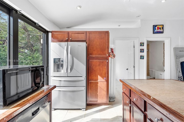 100 NE 51st St, Oakland Park, FL 33334 - kitchen with light tile patterned floors, recessed lighting, light countertops, appliances with stainless steel finishes, and vaulted ceiling