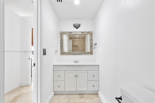 100 NE 51st St, Oakland Park, FL 33334 - bathroom with visible vents, toilet, vanity, baseboards, and walk in shower