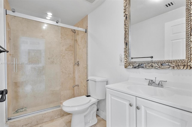 bathroom with tile patterned flooring, vanity, toilet, and walk in shower