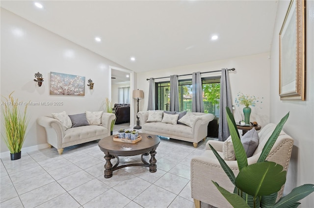 living room with light tile patterned floors and vaulted ceiling