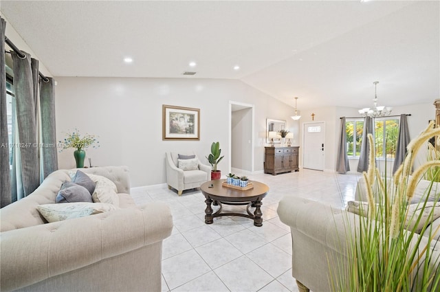 living room with lofted ceiling, light tile patterned floors, and a chandelier