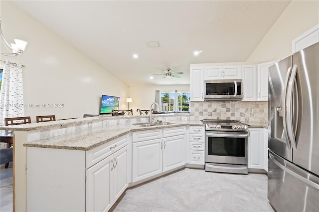 kitchen featuring white cabinets, stainless steel appliances, ceiling fan, and sink