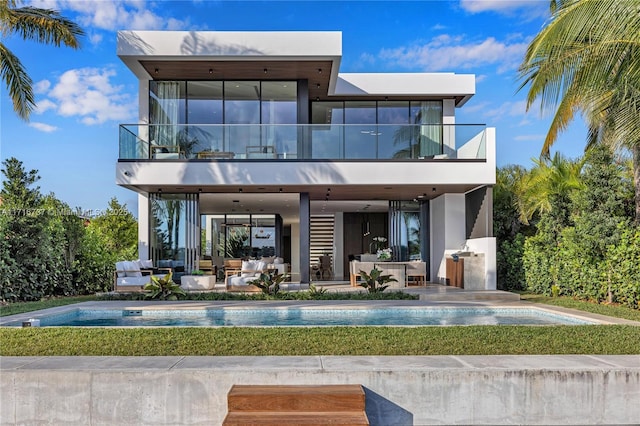 rear view of house featuring outdoor lounge area, a patio, a balcony, and area for grilling