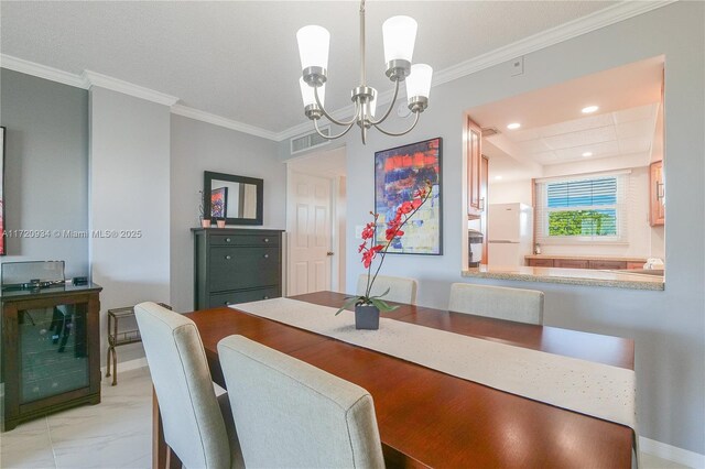 dining space featuring ornamental molding and an inviting chandelier