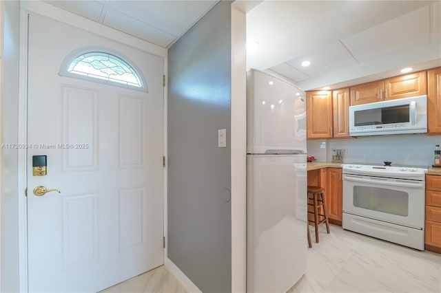 kitchen with decorative backsplash and white appliances