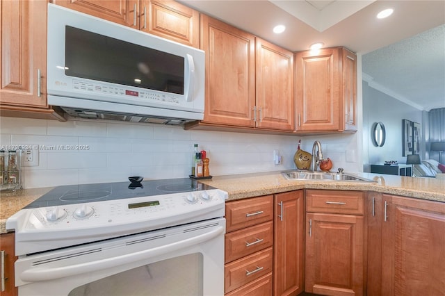 kitchen featuring tasteful backsplash, sink, and white appliances