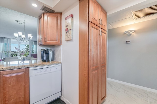 kitchen featuring decorative backsplash, light stone counters, pendant lighting, a notable chandelier, and dishwasher