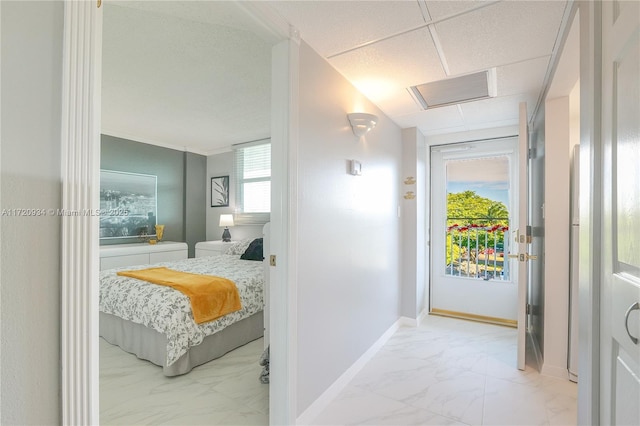 interior space with a paneled ceiling