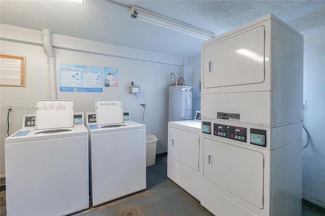 laundry room featuring electric water heater, washer and dryer, stacked washing maching and dryer, and a textured ceiling