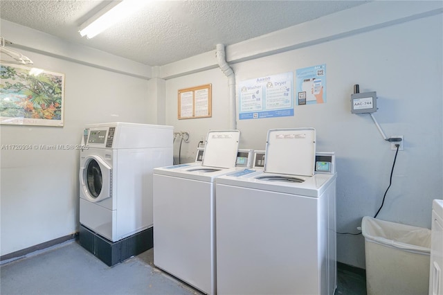 washroom with independent washer and dryer and a textured ceiling