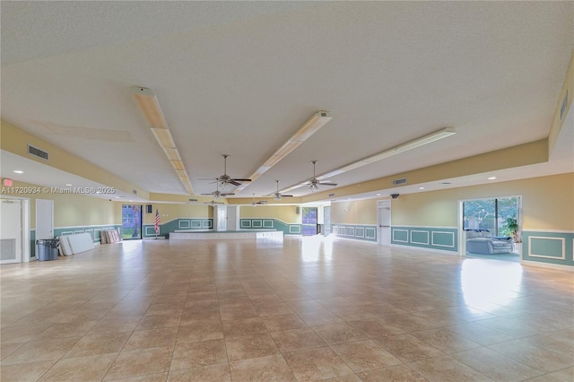 empty room with light tile patterned floors and ceiling fan