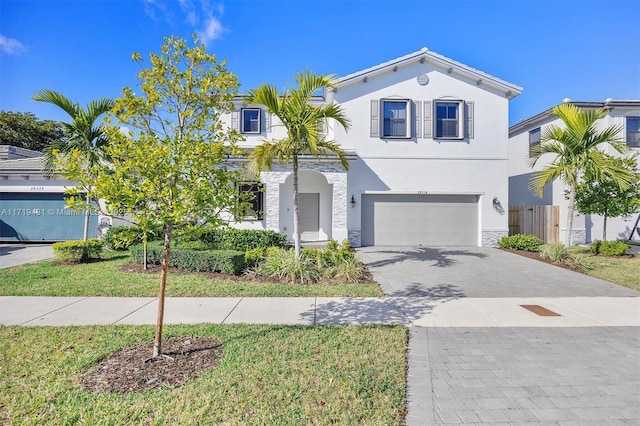 view of front of home with a garage and a front lawn