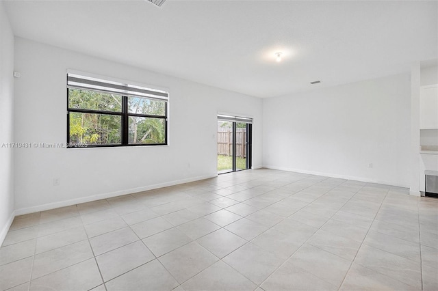 spare room featuring light tile patterned flooring