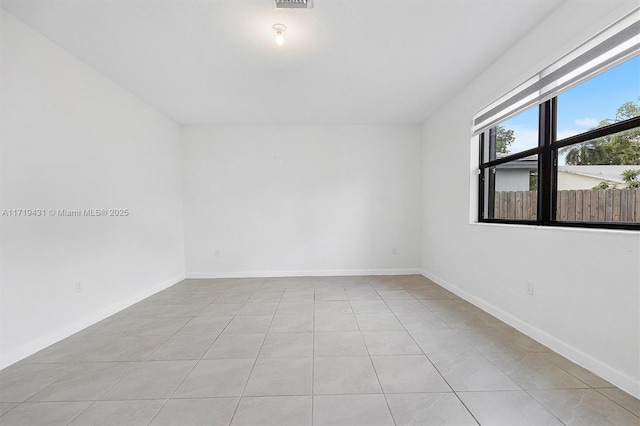 spare room featuring light tile patterned floors