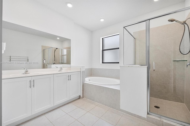 bathroom featuring tile patterned flooring, vanity, and shower with separate bathtub