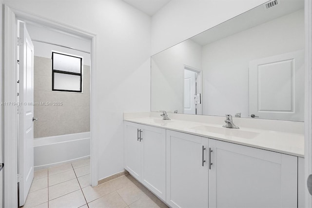 bathroom with vanity, tile patterned floors, and tiled shower / bath