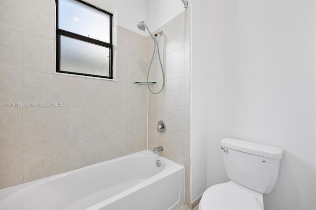 bathroom with tiled shower / bath and toilet