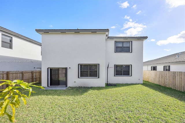 rear view of property featuring a yard