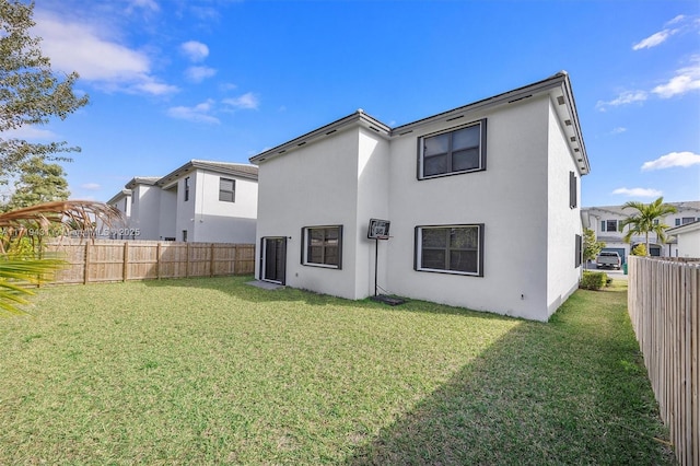 rear view of house with a yard