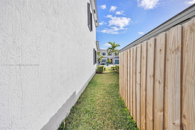 view of side of home featuring a lawn