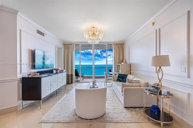 living room featuring visible vents, ornamental molding, floor to ceiling windows, a decorative wall, and a chandelier