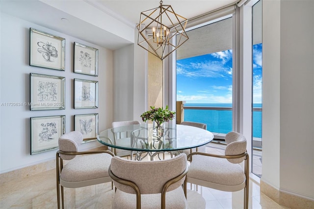 dining area featuring a notable chandelier and a water view