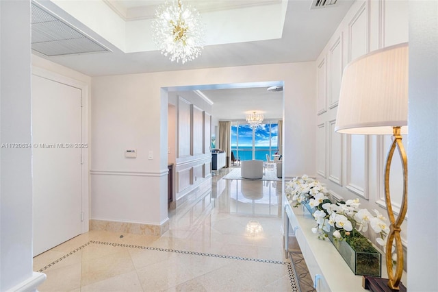 17875 Collins Ave Unit 3404, Sunny Isles Beach, FL 33160 - hallway with a chandelier, light tile patterned floors, inlaid floor details, and baseboards